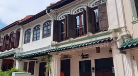 Colorful Peranakan houses and contrasting skyline in the heart of Singapore's main shopping belt