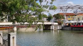 Serene scene at Singapore River. Due to the pandemic, all the bumboats are anchored. They are also know as lighters and used to carry goods to the warehouses located on the bank of the Singapore River.