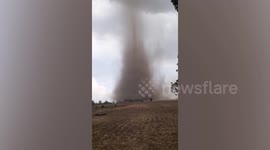 Large tornado forms over rice field and destroys houses in the Philippines