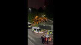 Police in riot gear in Brixton marching in response to reported incident
