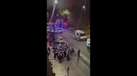 Police in riot gear march in Brixton to disperse crowd after reported incident