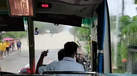 Bus drives through deep flood like boat during tropical storm Choi-wan in the Philippines