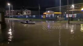 UK woman kayaks down busy industrial estate road to highlight problem of persistent flooding
