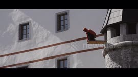 Daredevils perform a real-life Assassin’s Creed leap of faith - and jump into hay from a 55ft castle tower