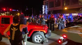 Police tow car away from scene after slashing its tires during a BLM protest.
