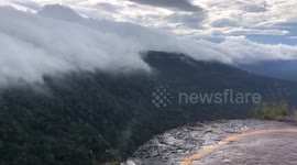 Beautiful sea of fog flies over mountain peaks and forest in Thailand