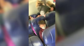 This is the moment a US woman punches a flight attendant in face and knocks out her TEETH