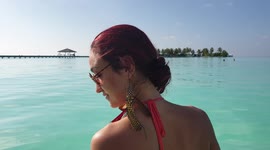 Tourist walking onto a beach in the maldives 3