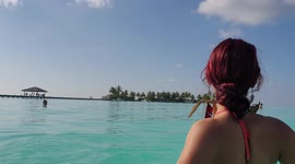Tourist walking onto a beach in the maldives 4