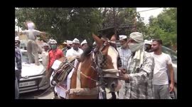 AAP workers demonstrated against rising inflation .Demonstration by mule pulling the car for skyrocketing petrol and diesel prices