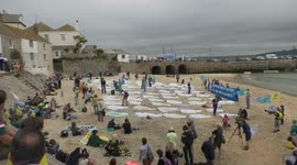 Environmental protesters place 'corpses' on St Ives beach at G-7 Summit