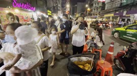 Trumpet player uses face mask with hole in it to play to passers-by in Thailand