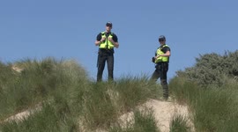 'Oh, I Do Like To Be Beside the Seaside' - G-7 Police officers take time out to photograph one another by the beach
