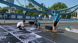 Tower bridge portraits pasted onto the tarmac