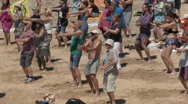 G-7: Protesters perform mass dance to 'Stayin' Alive' on St Ives Beach