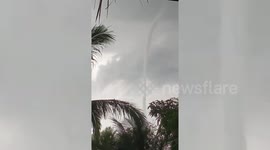 Long waterspout forms near homes in the Philippines