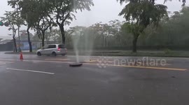 Dirty water bursts out from road drainage after rain storm in Taiwan