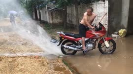 Creative Chinese man uses motorcycle to propel floodwater away from house