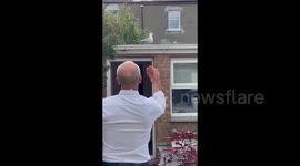 A man feeds seagulls in his back garden in Dublin, Ireland