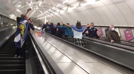 Scottish football fans ride London Underground escalator after midnight