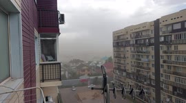 Strong winds carry huge dust masses creating a dust storm and a floating plastic bag