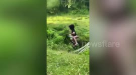 Cyclist shows off bike skills to a friend before falling into a ditch