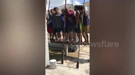 Creative builders in Thailand jump on plank to sink pillar using their weight