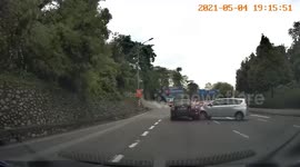 Lucky motorcyclist emerges unscathed after being sandwiched between two cars in crash