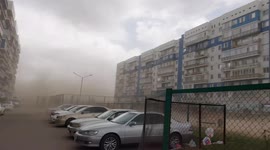 Huge dust storm caused by strong winds carrying debris from nearby construction sites