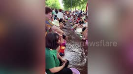 Thousands of locals enjoy foot spa in hot spring that sprays out onto streets in China