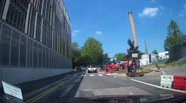 Digger driver at Nortwick Park Hospital construction site oblivious to other road users, at 33 seconds pulls straight out with out looking