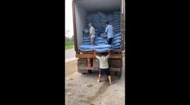 Men use their heads and shoulders to transport tens of tons of goods every day