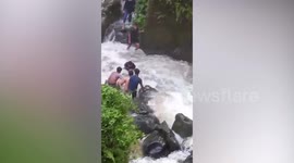 Youngsters rescue two tourists trapped in raging waterfall in Indonesia