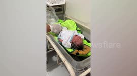 Abandoned baby boy found alive in rucksack hanging on a fence in the Philippines