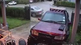 Man slips on wet driveway in front of house after heavy rain