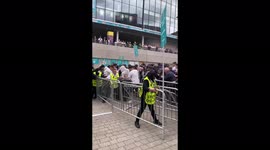 Fans attempt to storm Wembley barriers, trapping people in heap of bodies