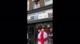 Wembley locals help English fans with beers as they wait in line for the pub