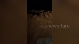 Muddy flash flood sweeps through street during storm in the Philippines