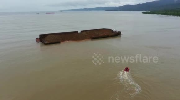 Huge barge carrying 6,000 tons of nickel partially capsizes off Indonesian coast