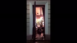 Waiter rakes the water out of the establishment after a downpour in Minsk, Belarus