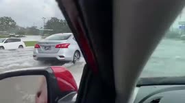 Cars drive through floods in Erlanger, Germany