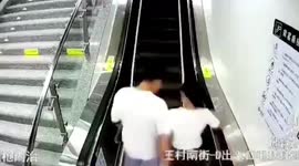 Couple falls from escalator after kissing each other as it moves up in China