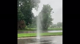 Water bursts from manhole as storm brings heavy rain in Michigan