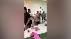 Skilful waiter carries nearly 20 wine glass in one arm