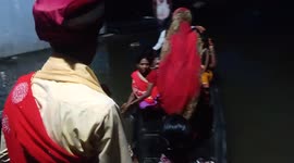 Indian groom forced to cross floodwaters in boat to get to ceremony