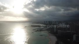 Drone video flying above Oahu, waikiki beach. slow dramatic video with sun and clouds aerial shots.