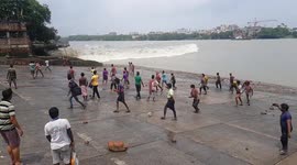 Spectators in northeastern India run for it as crazy river wave approaches