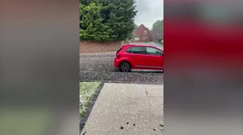 Hail stones the size of GOLF BALLS smash through car windows in the UK during freak weather