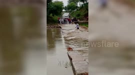 Appearing inebriate, a man intends to cross a strong river current but gets swept away in central India