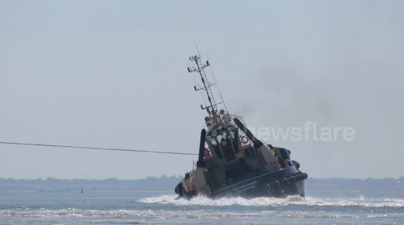 Tug boat nearly capsized by gigantic container ship at Felixstowe port in Suffolk